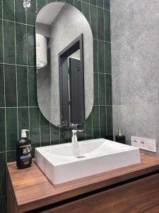 a bathroom with a white sink and a mirror at Апартаменти біля моря in Odesa