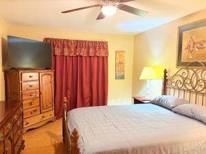 a bedroom with a bed and a flat screen tv at West Tawakoni Lake House in West Tawakoni