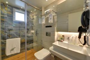 a bathroom with a shower and a toilet and a sink at The Fern Residency Mumbai, Mira Road, Series by Marriott in Mumbai +43 photos