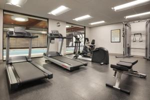 a gym with several treadmills and elliptical machines at Country Inn & Suites Asheville River Arts District in Asheville
