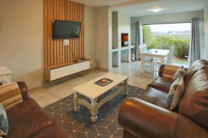 a living room with a couch and a coffee table at Bella Casa, Langebaan, 4-sleeper in Langebaan