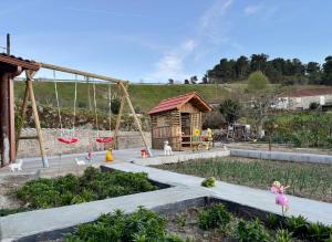 a playground with toy dolls and a swing at Casinha da Ti'Augusta in Lamego