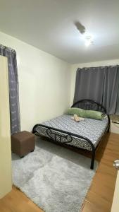 a bedroom with a bed with a black headboard at Budget-friendly Unit in Davao City +4 photos