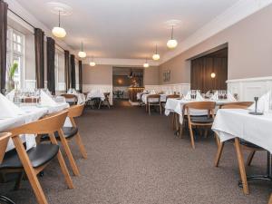 a dining room with white tables and chairs at 4 person holiday park home in Give in Give