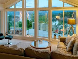 a living room with a couch and a large window at 4 star holiday home in Valevåg in Valevåg