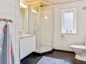 a bathroom with a glass shower and a toilet at 4 star holiday home in Valevåg in Valevåg