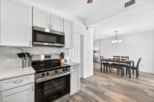 a kitchen with a stove and a dining room at Buffalo Bungalow in Clearwater Beach