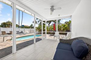 a patio with a couch and a swimming pool at Buffalo Bungalow in Clearwater Beach