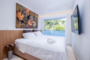 Postel nebo postele na pokoji v ubytování Cobertura c/jacuzzi e churrasq em Jurerê RVO401 + 22 fotografií