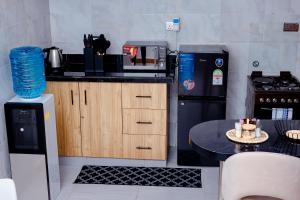 a small kitchen with a table and a microwave at Sereno Escape in Meru