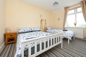 a bedroom with two beds and a window at Hunstanton Holidays Flat 3 with seaview in Hunstanton