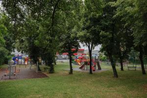 a park with a playground with a slide and trees at TripON cozy spot in Cluj-Napoca