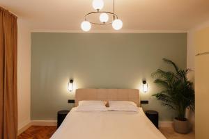 a bedroom with a bed with two pillows on it at TripON cozy spot in Cluj-Napoca