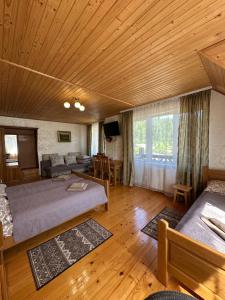 a large room with two beds and a couch at Гостинний двір Стефані in Tatariv