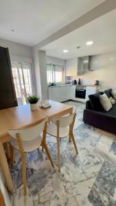 a living room with a table and a couch at Golden Hour Grupo AC Gestión in Rota +15 photos