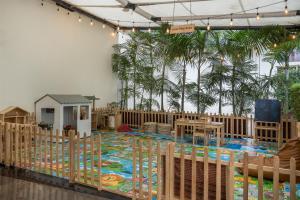 a nursery with a crib and a play area with trees at Radisson Blu Hotel & Convention Centre Kigali in Kigali