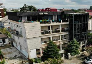 an apartment building with people sitting on the balcony at TIRKIUS House in Kobuleti