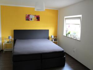 a bedroom with a bed and a window at Ferienhaus in Schwarzhausen in Schwarzhausen