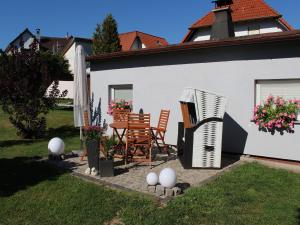 a white house with a table and chairs and eggs at Ferienhaus in Schwarzhausen in Schwarzhausen +32 photos