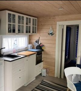 a kitchen with white cabinets and a counter top at Hausboot Bella Vista am Müritznationalpark FESTANLIEGEND in Mirow