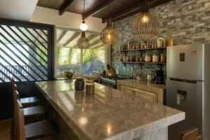 a kitchen with a large counter and a refrigerator at La Casita de Orfi in Calca