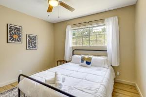 a bedroom with a white bed with a window at Group-Friendly Getaway with Fenced Yard in Temple! in Temple