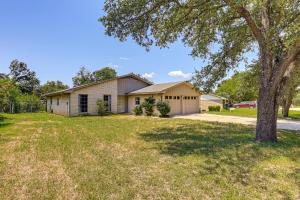 a house with a tree in front of a yard at Group-Friendly Getaway with Fenced Yard in Temple! in Temple