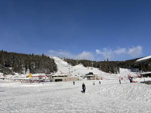 a group of people skiing down a snow covered slope at Bienvenue au chalet in Bolquere Pyrenees 2000