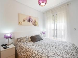 a white bedroom with a bed and a window at Modern Garden Home, Algorfa in Ciudad Quesada