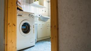 a kitchen with a washing machine and a sink at Ferienholzhaus in Sankt Gallen im Gesäuse in der Steiermark in Sankt Gallen