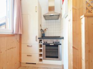 a small kitchen with a stove and a sink at Chalet in Stadl nahe Kreischberg Pisten in Stadl an der Mur +25 photos
