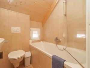 a bathroom with a tub and a toilet and a sink at Chalet in Stadl nahe Kreischberg Pisten in Stadl an der Mur