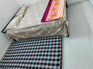 a bed with two ties on top of it at Choudhary Guest House in Khātu