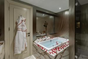 a bathroom with a tub with red hearts on it at Grand Opera Hotel & Casino & Spa in Kérynia