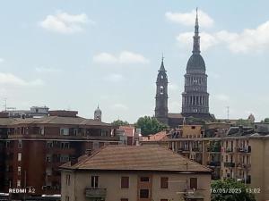 a view of a city with buildings and a clock tower at Noemi House & Rooms in Novara