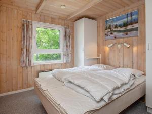 a bedroom with a large bed with a window at 5 star holiday home in Jerup in Jerup +32 photos