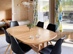 a wooden table in a room with chairs around it at 6 person holiday home in Jerup-By Traum in Jerup +19 photos