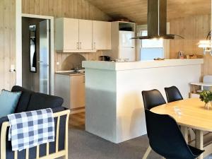 a kitchen and dining room with a table and chairs at 5 star holiday home in Jerup in Jerup