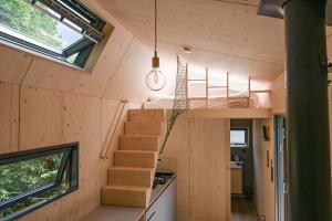 a tiny house with a staircase in the middle at Tiny House Pioneer 6 - Green Tiny Village Harz in Osterode