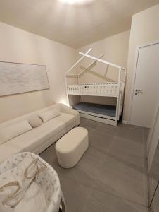 a living room with a couch and a baby crib at San Lorenzo Exclusive in San Lorenzo al Mare +12 photos