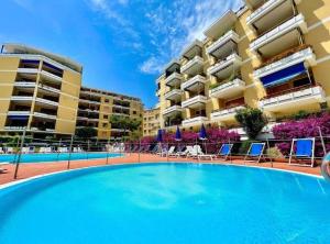 a large swimming pool in front of a building at San Lorenzo Exclusive in San Lorenzo al Mare