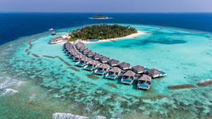 an island with overwater bungalows in the ocean at Nova Maldives in Dhangethi