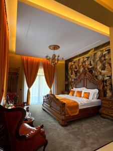 a bedroom with a large bed with a large painting on the wall at La Casa Boutique in Kostinbrod