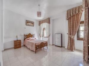 a bedroom with a bed and a dresser and a window at Holiday Home in Villanueva near El Terril Peak in Villanueva de San Juan