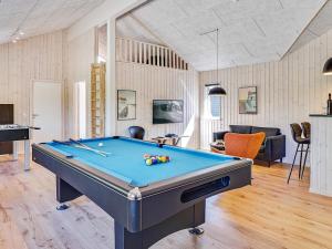 a pool table in a living room with a pool at 5 star holiday home in Fjerritslev in Fjerritslev