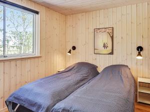 a bedroom with a bed and a window at 5 star holiday home in Fjerritslev in Fjerritslev