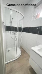 a glass shower in a bathroom with a sink at Kim Homestay B Zimmer 2 in Sömmerda