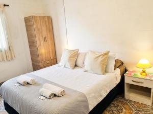 ein Schlafzimmer mit einem Bett mit Handtüchern darauf in der Unterkunft Hospedaje Familiar Arcoíris Jujuy in San Salvador de Jujuy