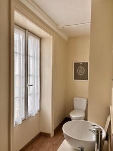 a bathroom with a sink and a toilet and a window at La Belle Vienne in Exideuil +62 photos