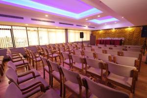 a room with rows of chairs and a podium at Nexstay Hotel Calicut Gate in Kozhikode